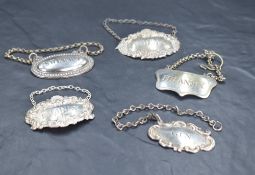 Two Queen Elizabeth II silver spirit labels, embossed with scallop shell and scrolls, named Whisky