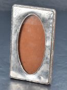 A George V silver mounted photograph frame, of oblong form with moulded edge detail, engraved