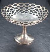 A George V silver pedestal dish, of dished circular form with repeating pierced oval design,