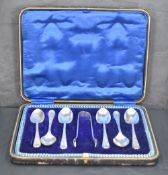 A cased set of six George V silver teaspoons and sugar tongs, engraved with foliate detail, marks