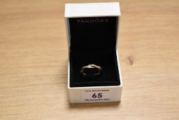 A Pandora Twist of Faith style ring, with box