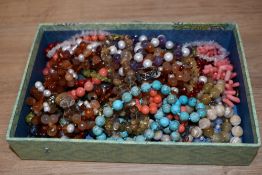 An assorted collection of coloured bead necklaces, nugget shaped bead necklaces, and wedding cake