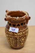 A Victorian slipware puzzle jug, measuring 15cm tall