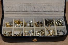 A black leather Rowallan jewellery box containing pearl style earrings, stud earrings, and others