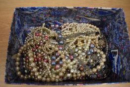 An assorted collection of simulated pearl necklaces, including a multicoloured bead necklace