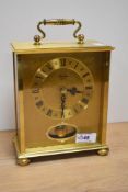 A brass 'Timemaster' mantel clock in German case.