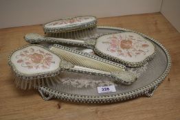 An early-mid 20th Century dressing table set, having an embroidered floral design, and comprising