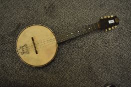 A vintage John Grey Banjolele, serial number G3697, with vintage case in disrepair