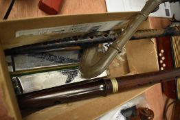 A selection of small musical instruments and novelties including flute and penny whistle