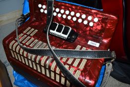 An unbranded button accordion, no case