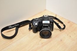 A Canon SX50 HS digiral camera with Canon zoom lens 50x15 4.3-215mm 1:3,5-6,5. No battery or