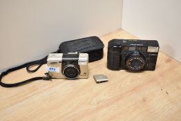 A Canon Sureshot with Canon 38mm lens and a Samsung Rocas 300 camera (as Found)