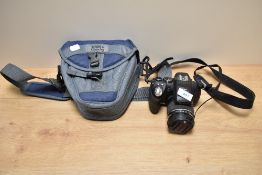 A Fujifilm Finepix digital camera with Fujinon 30x f:4,2-126 1:2,8-5,6 lens