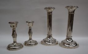 A pair of George V silver desk candlesticks, with ring turned columns on a spreading foot,