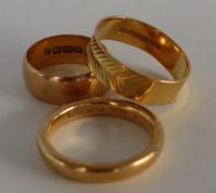 A 22ct yellow gold wedding band, with a half textured body,