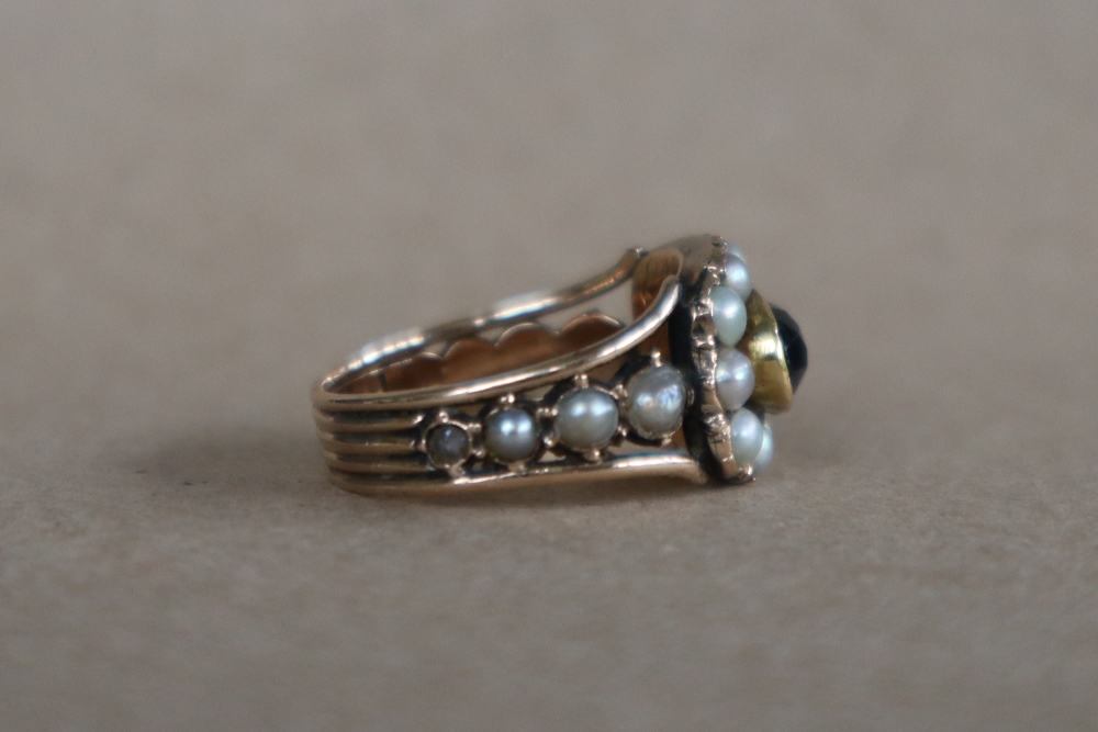 A late George III mourning ring set with a central oval faceted amethyst surrounded by half section - Image 3 of 6