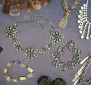 A white metal and enamel decorated necklace in the form of three flower heads,