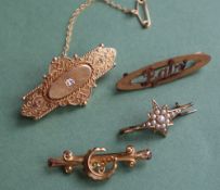 A Victorian 15ct gold bar brooch set with a cushion cut diamond set in a raised oval panel