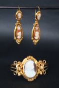 A 19th century continental yellow metal shell cameo bangle together with a pair of yellow metal