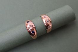 An 18ct gold sapphire and diamond gypsy ring set with two round faceted sapphires and a central old