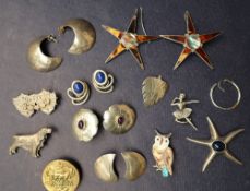 A collection of silver earrings,