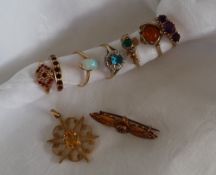 A 9ct yellow gold amethyst three stone ring, size R 1/2 together with six other 9ct gold rings,