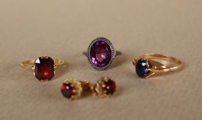 A yellow metal dress ring set with an oval faceted sapphire to a yellow metal setting and shank,