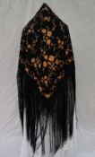 A silk piano shawl, the black ground decorated with embroidered gold roses and other flowers,