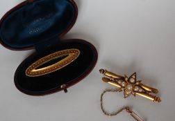 A 15ct gold bar brooch of double baton form with an enamel outlined, pearl set star,