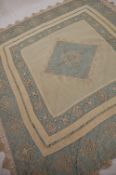 A teal silk table cloth / bed cover, with a cream bobbin lace overlay,
