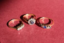 A sapphire and diamond five stone ring set with three sapphires and two old round cut diamonds to