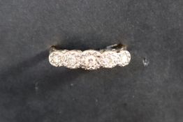 A five stone diamond ring set with graduated old cut diamonds to a white metal setting and 18ct