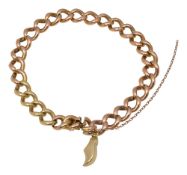 A gold curb link charm bracelet