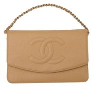 A Chanel beige leather cross body wallet on a chain