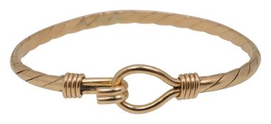 A gold stiff twist hook and eye bangle