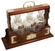 An Edwardian oak and silver plate mounted tantalus