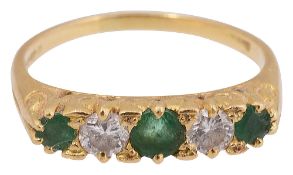 An emerald and diamond five stone ring