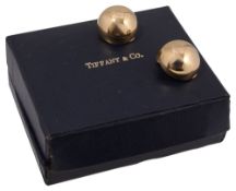 A pair of round ear clips by Tiffany & Co.