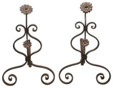 A pair of Edwardian Arts and Crafts wrought iron andirons