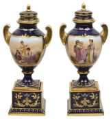 A pair of late 19th century Vienna style porcelain urns and covers