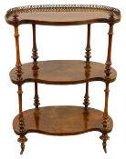 A Victorian figured walnut three tier etagere