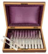 A set of twelve mother of pearl handled dessert knives and forks