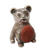 A contemporary silver pin cushion in the form of a teddy bear