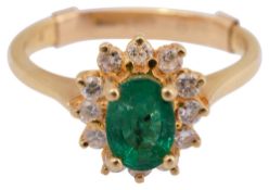 An emerald and diamond-set cluster ring