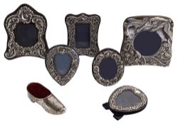 Six modern small embossed silver photograph frames and a novelty