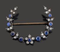 A sapphire and diamond crescent brooch