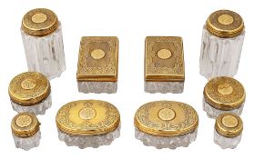 A mid Victorian set of ten silver-gilt lidded cut glass toilet jars retailed by Asprey