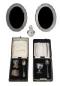 Two silver christening sets, two silver frames and a pepperette