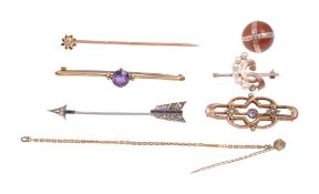 A collection of brooches and stick pins