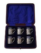 A George V cased set of silver mounted liqueur glasses